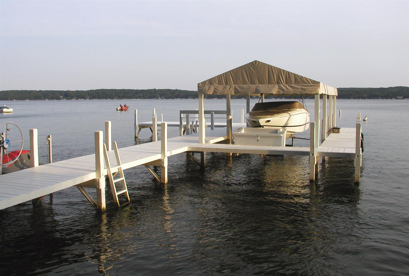 Pier with canopy and boat lift at golden hour on Geneva Lake