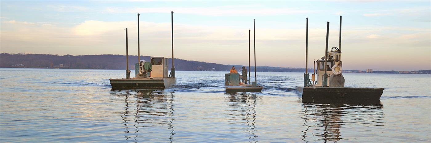 Reed's Construction barges heading out on Geneva Lake at dusk